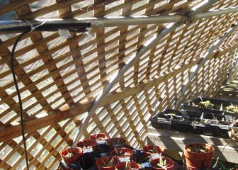 Misting sprayer tied to cross brace of shadehouse